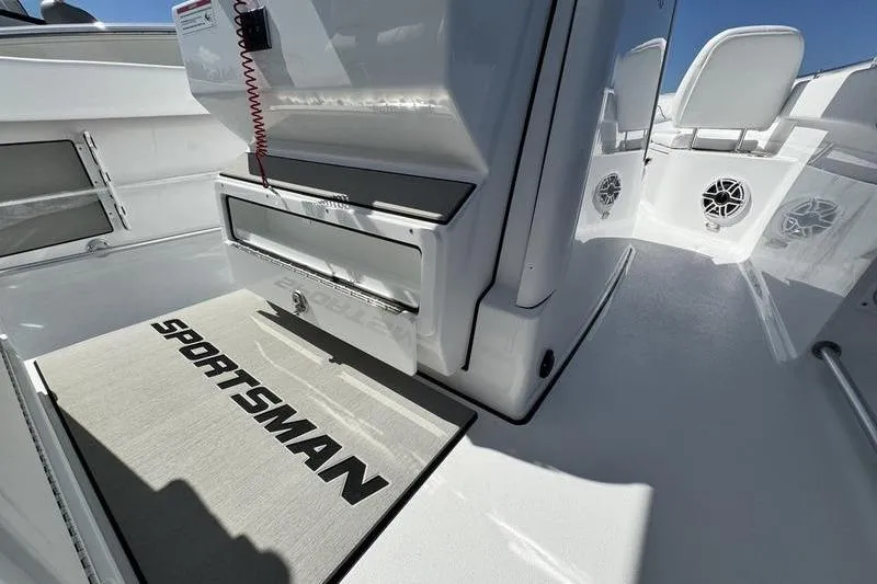 Slide: The Image of 2026 Sportsman Open 262 Center Console interior with branded mat and storage compartments. - 22