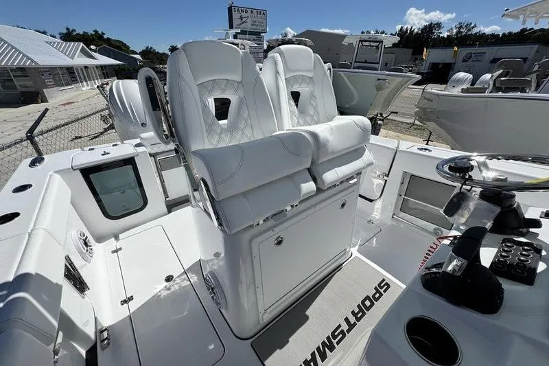 Slide: The Image of 2026 Sportsman Open 262 Center Console boat with white seating and modern controls. - 23