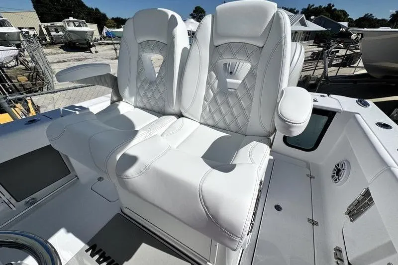 Slide: The Image of Luxury seating on 2026 Sportsman Open 262 Center Console boat, featuring white leather upholstery. - 24