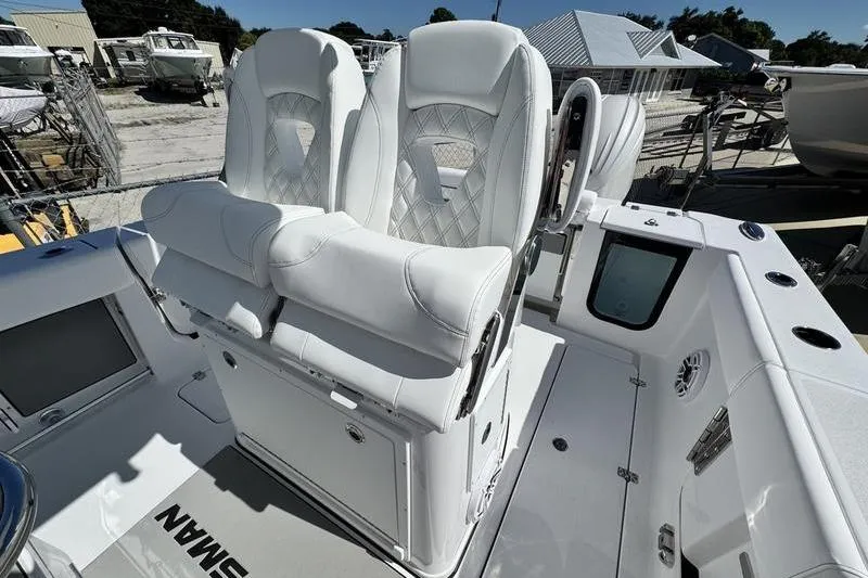 Slide: The Image of 2026 Sportsman Open 262 Center Console with luxurious white seating and modern dashboard. - 28
