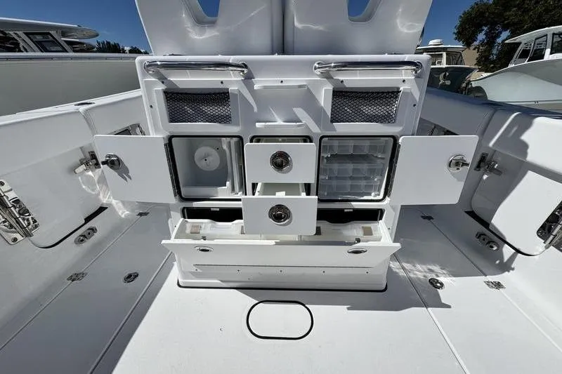 Slide: The Image of 2026 Sportsman Open 262 Center Console boat interior with storage compartments open. - 29