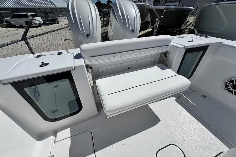 Slide: The Image of 2026 Sportsman Open 262 Center Console boat interior with seating and dual engines. - 32