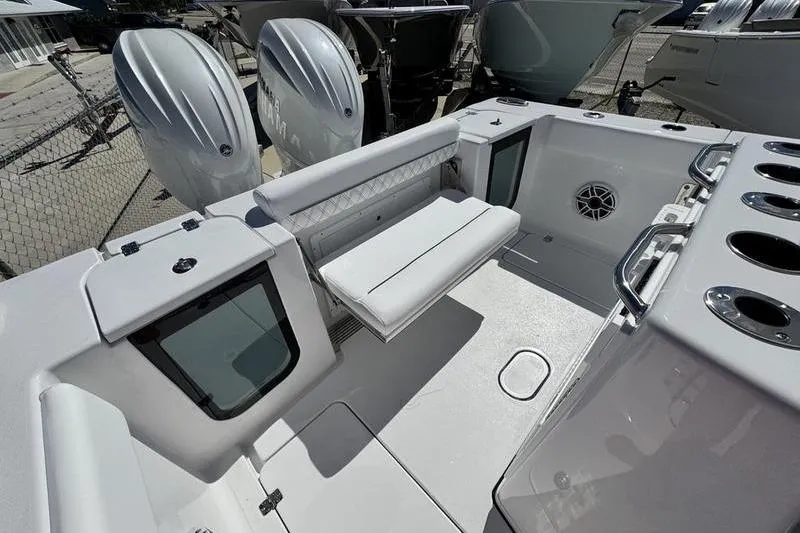 Slide: The Image of 2026 Sportsman Open 262 Center Console boat interior with seating and dual engines. - 33