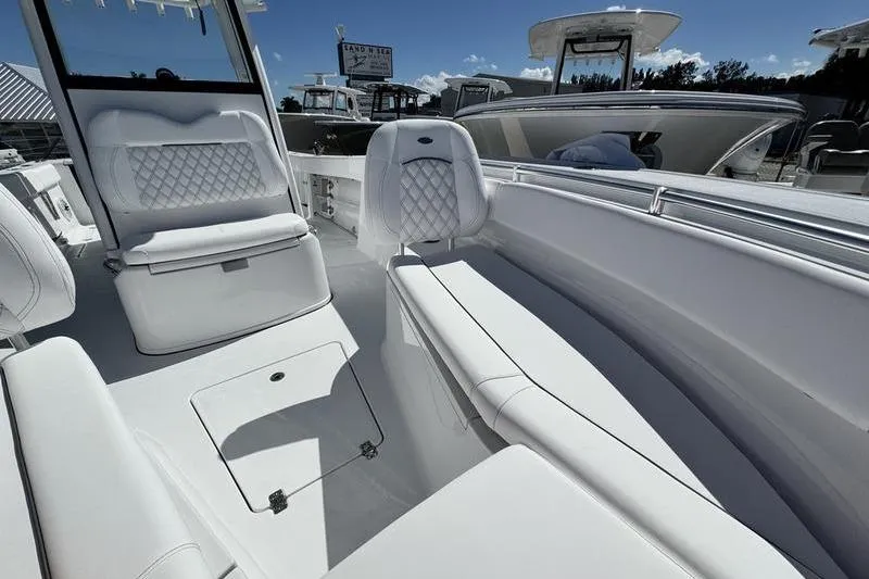 Slide: The Image of 2026 Sportsman Open 262 Center Console boat interior with white seating and modern design. - 7