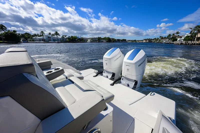Slide: The Image of 2022 Tiara Yachts 43 LE with dual Mercury engines on a sunny waterway. - 10