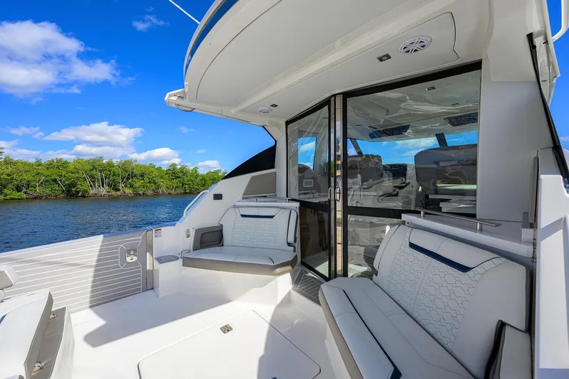 Slide: The Image of 2022 Tiara Yachts 43 LE luxury yacht interior with seating, river view, and blue sky. - 26