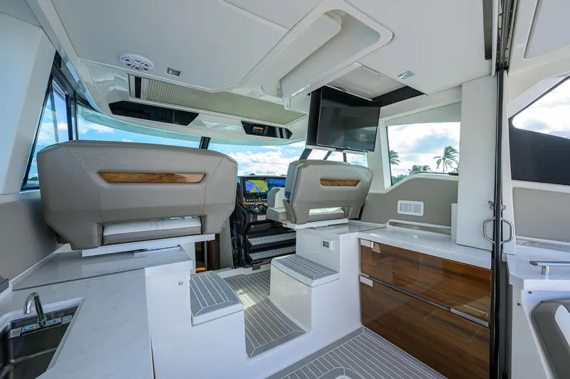 Slide: The Image of Luxurious interior of 2022 Tiara Yachts 43 LE, featuring modern seating and navigation equipment. - 30