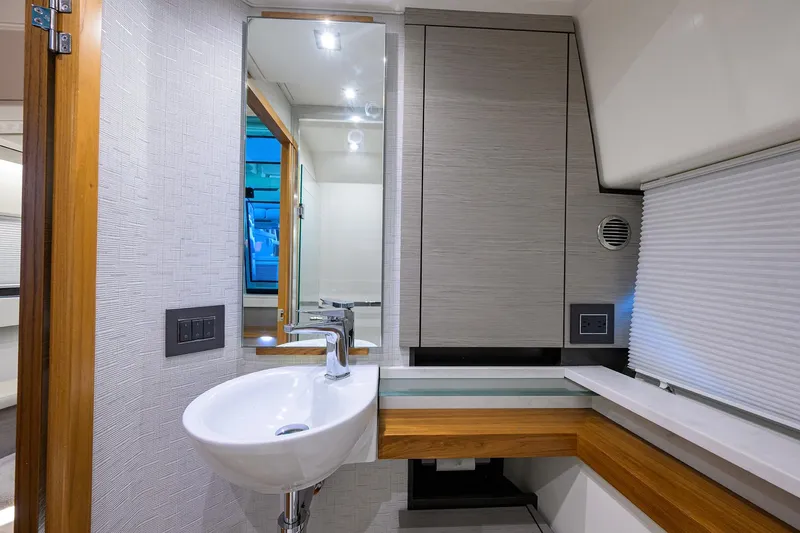 Slide: The Image of 2022 Tiara Yachts 43 LE bathroom with modern sink and sleek cabinetry. - 50