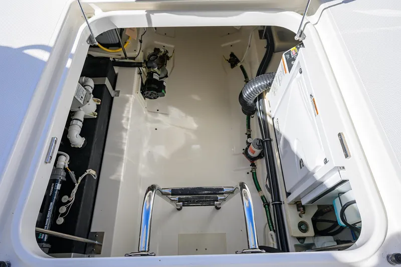 Slide: The Image of Engine compartment of 2022 Tiara Yachts 43 LE, showcasing mechanical components and systems. - 52