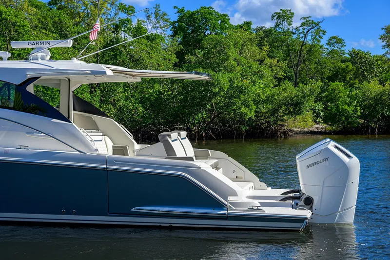 Slide: The Image of 2022 Tiara Yachts 43 LE in water, featuring sleek design and Mercury outboard engine. - 8