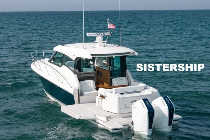 Slide: The Image of 2022 Tiara Yachts 43 LE cruising on open water, showcasing sleek design and twin engines. - 9