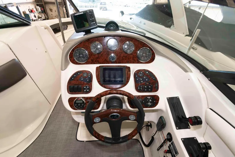 Slide: The Image of 2006 Sea Ray 290 SLX boat dashboard with steering wheel and navigation controls. - 10