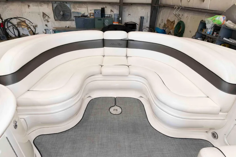 Slide: The Image of 2006 Sea Ray 290 SLX boat interior with white leather seating in a workshop setting. - 12