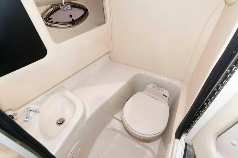 Slide: The Image of 2006 Sea Ray 290 SLX boat bathroom with toilet and sink. - 16