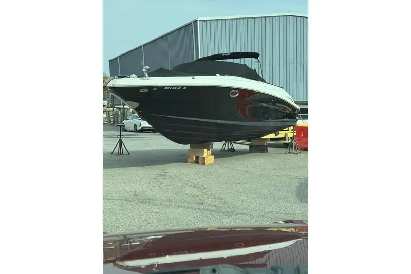 Slide: The Image of 2006 Sea Ray 290 SLX boat on stands in a marina storage area. - 3