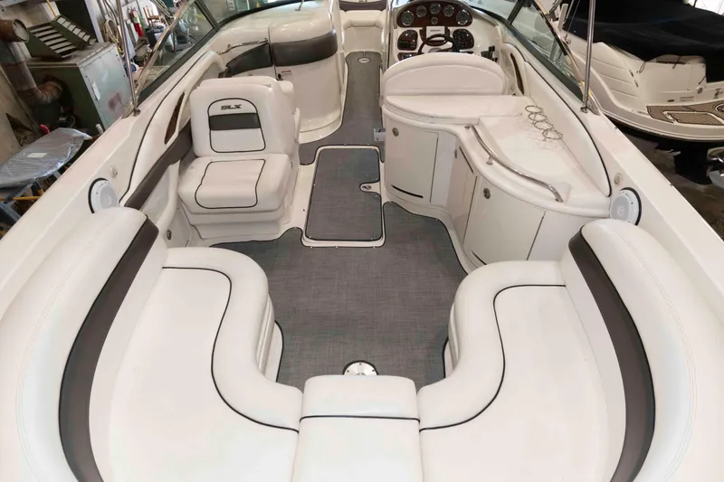 Slide: The Image of Interior of 2006 Sea Ray 290 SLX boat with white seating and dashboard. - 4