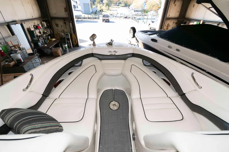 Slide: The Image of Interior of a 2006 Sea Ray 290 SLX boat with white seating and modern design. - 5