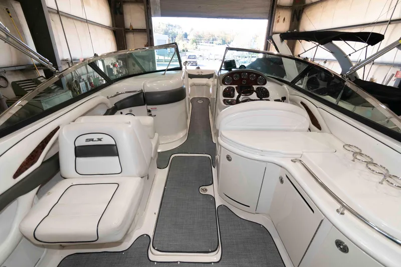 Slide: The Image of 2006 Sea Ray 290 SLX boat interior with seating and dashboard in a garage. - 6