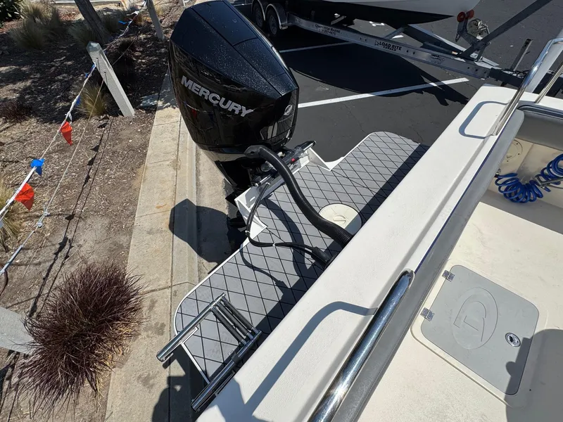 Slide: The Image of 2023 Defiance Admiral 220 EX boat docked at a marina under clear blue skies. - 14