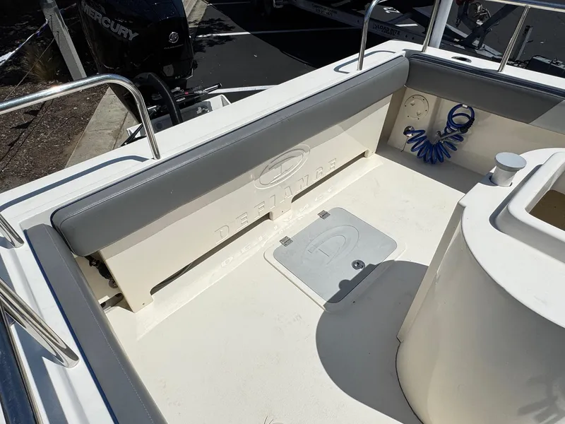 Slide: The Image of 2023 Defiance Admiral 220 EX with Mercury outboard engine at marina. - 16