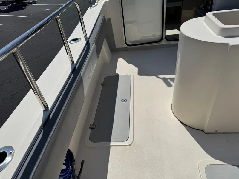 Slide: The Image of 2023 Defiance Admiral 220 EX boat docked at marina, spacious deck, clear skies. - 18