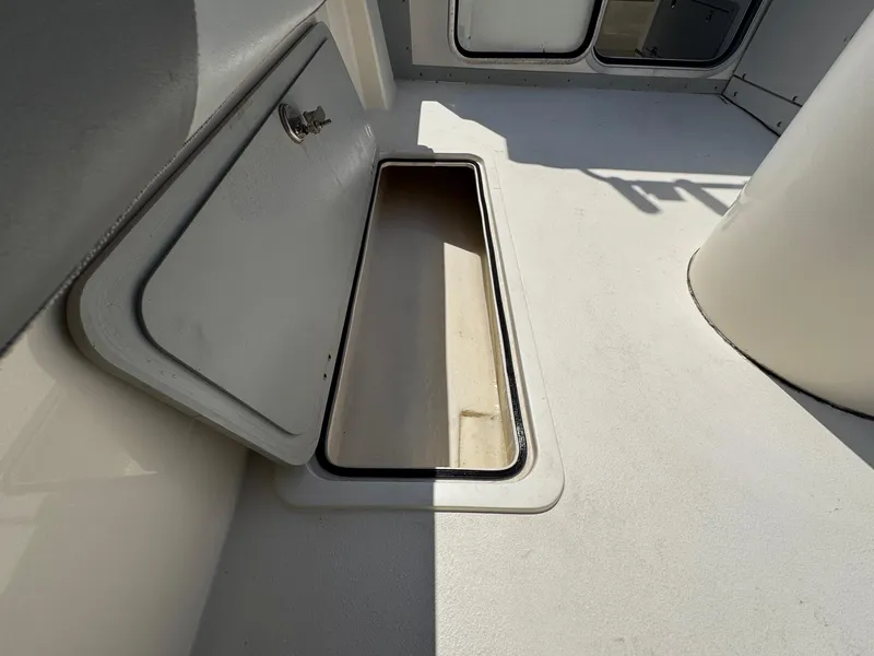 Slide: The Image of 2023 Defiance Admiral 220 EX boat deck with storage compartments and seating. - 19