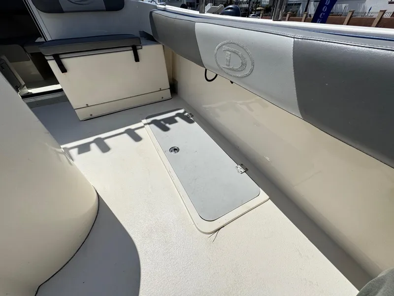 Slide: The Image of 2023 Defiance Admiral 220 EX boat interior with seating and storage compartments. - 20