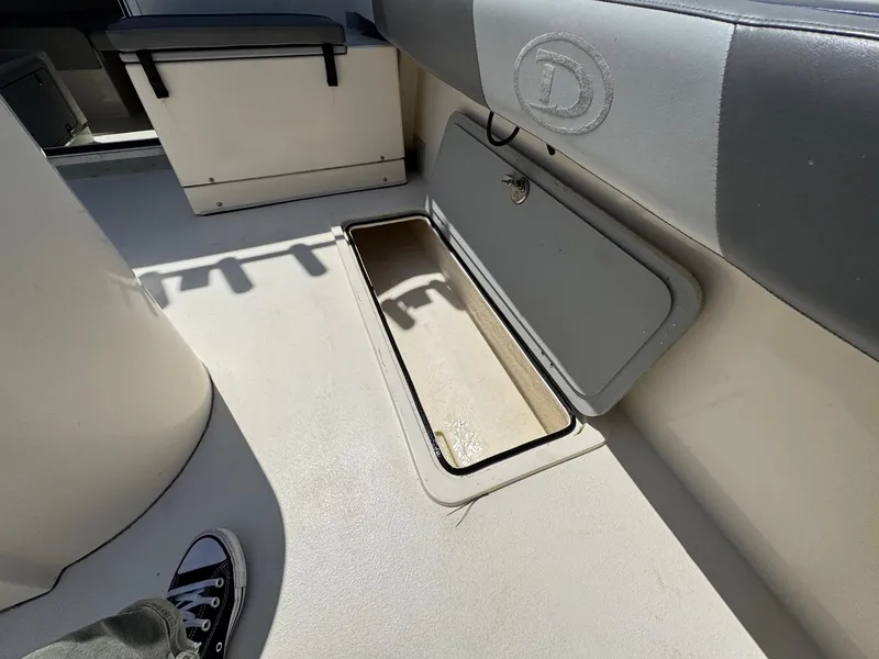 Slide: The Image of 2023 Defiance Admiral 220 EX boat interior with seating and storage. - 21