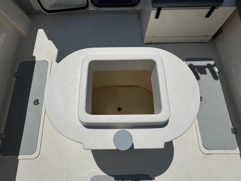 Slide: The Image of 2023 Defiance Admiral 220 EX boat storage compartment, open and empty. - 23