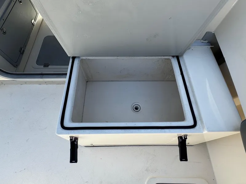 Slide: The Image of 2023 Defiance Admiral 220 EX boat interior with open storage compartment. - 25