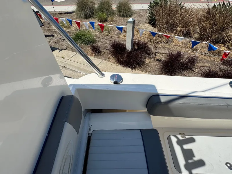 Slide: The Image of 2023 Defiance Admiral 220 EX boat deck with storage hatch and branding. - 26