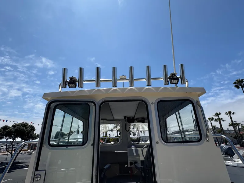 Slide: The Image of Open hatch on 2023 Defiance Admiral 220 EX boat deck, revealing interior compartment. - 27