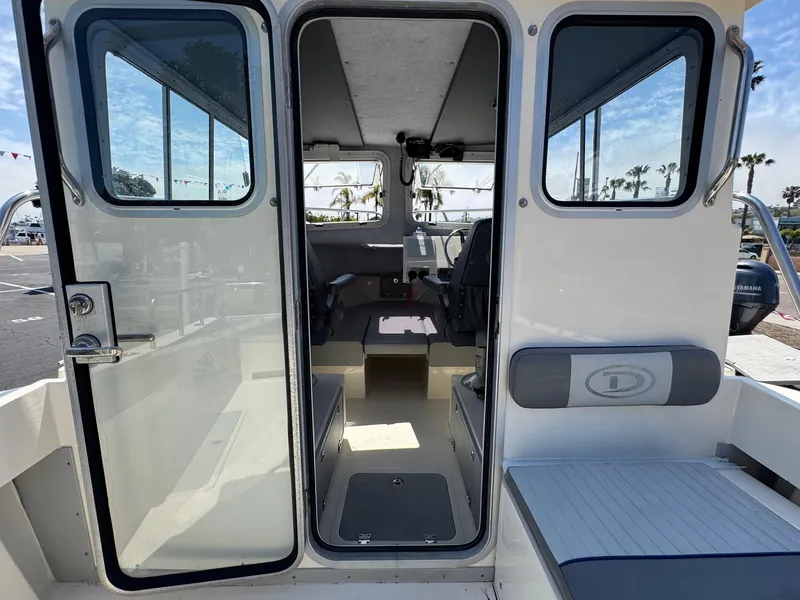 Slide: The Image of Open hatch of 2023 Defiance Admiral 220 EX boat, showing interior components and wiring. - 28