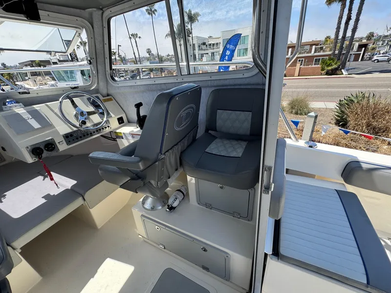 Slide: The Image of 2023 Defiance Admiral 220 EX boat docked at marina under clear blue sky. - 29