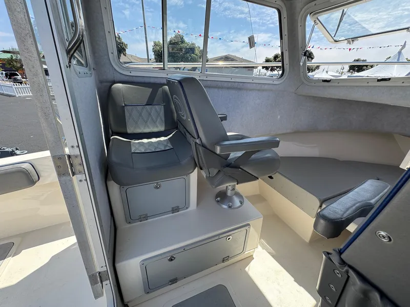 Slide: The Image of 2023 Defiance Admiral 220 EX boat interior with seating and storage compartment. - 30