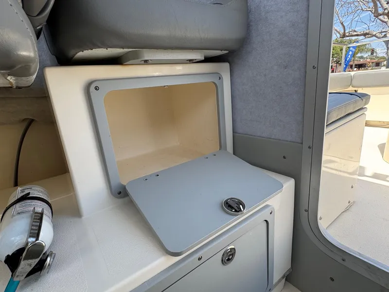 Slide: The Image of Interior of 2023 Defiance Admiral 220 EX boat with helm and seating. - 33