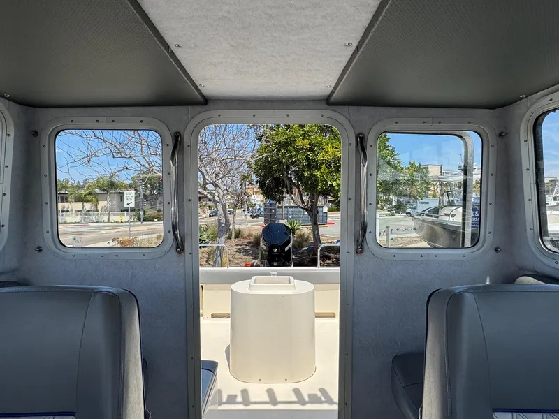 Slide: The Image of 2023 Defiance Admiral 220 EX boat interior storage compartment with open hatch. - 38