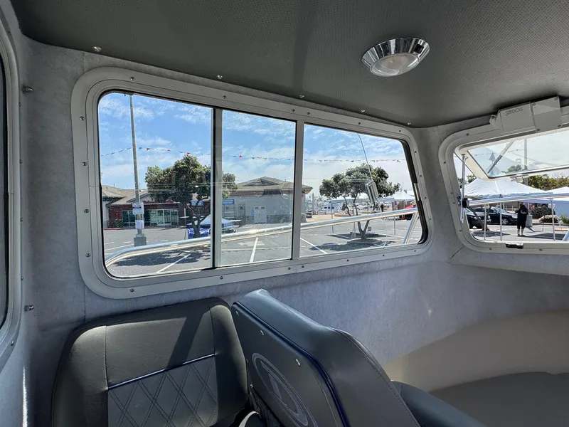 Slide: The Image of Interior of 2023 Defiance Admiral 220 EX boat with cushioned seating and storage. - 39