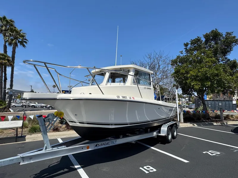 Slide: The Image of 2023 Defiance Admiral 220 EX boat docked at marina, sunny day. - 4