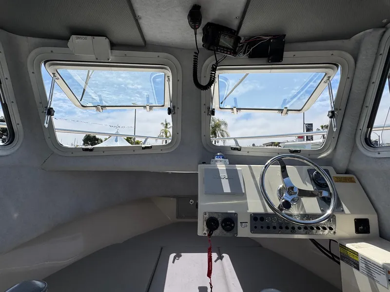 Slide: The Image of 2023 Defiance Admiral 220 EX boat interior seating with storage compartment. - 40