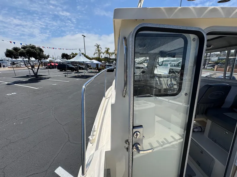 Slide: The Image of Interior view of 2023 Defiance Admiral 220 EX boat at marina dock. - 47