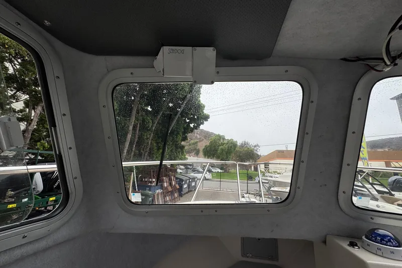 Slide: The Image of 2023 Defiance Admiral 220 EX boat docked at marina, showcasing sleek design and sturdy build. - 49