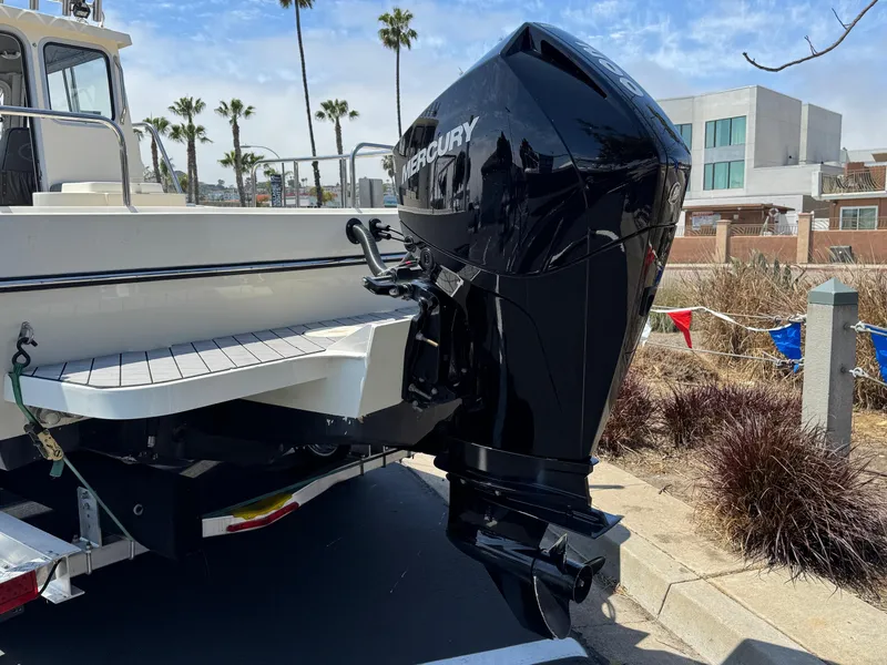 Slide: The Image of 2023 Defiance Admiral 220 EX boat docked at marina under clear blue sky. - 9