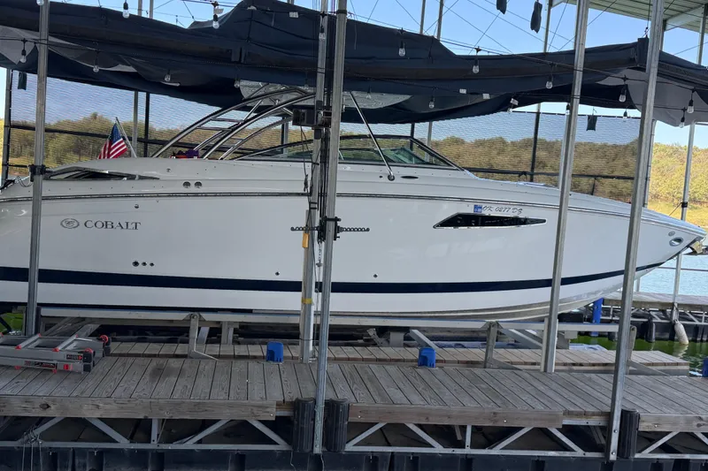 Slide: The Image of 2018 Cobalt R35 boat docked in a covered marina, side view. - 1