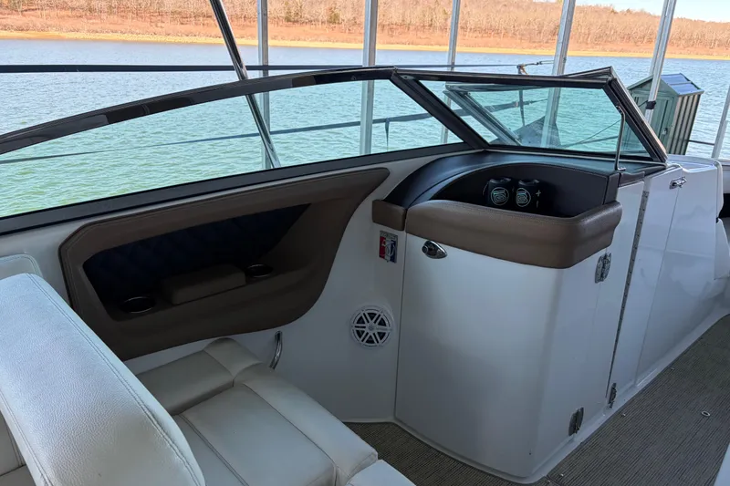 Slide: The Image of Interior of a 2018 Cobalt R35 boat with seating and dashboard, overlooking a serene lake. - 14
