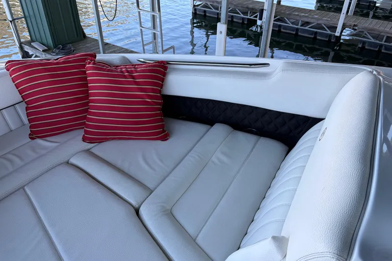 Slide: The Image of Luxurious 2018 Cobalt R35 boat interior with white seating and red striped cushions. - 18