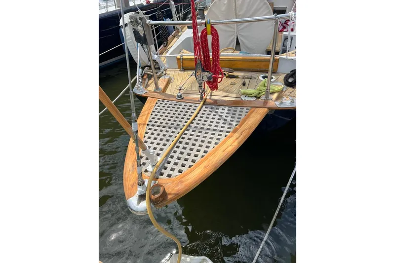 Slide: The Image of Bow of 1980 F&C 44 sailboat with wooden deck and nautical equipment. - 12