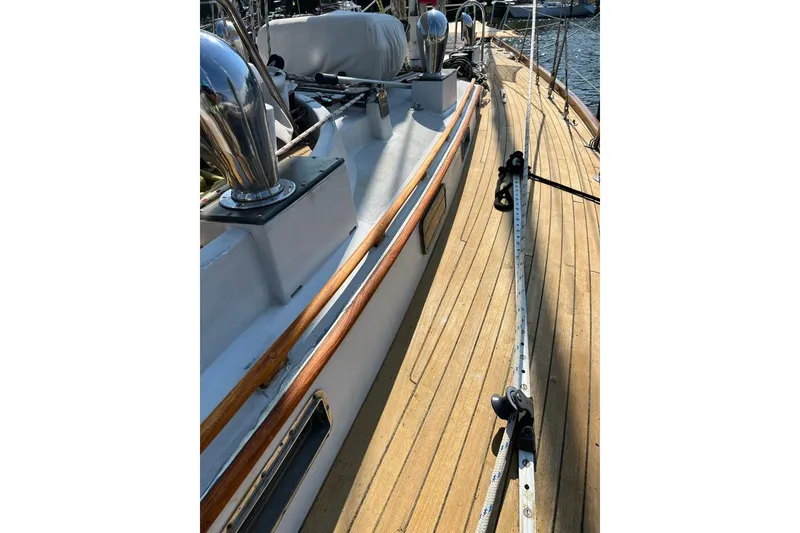 Slide: The Image of Deck of 1980 F&C 44 sailboat with wooden finish and metal fittings. - 15