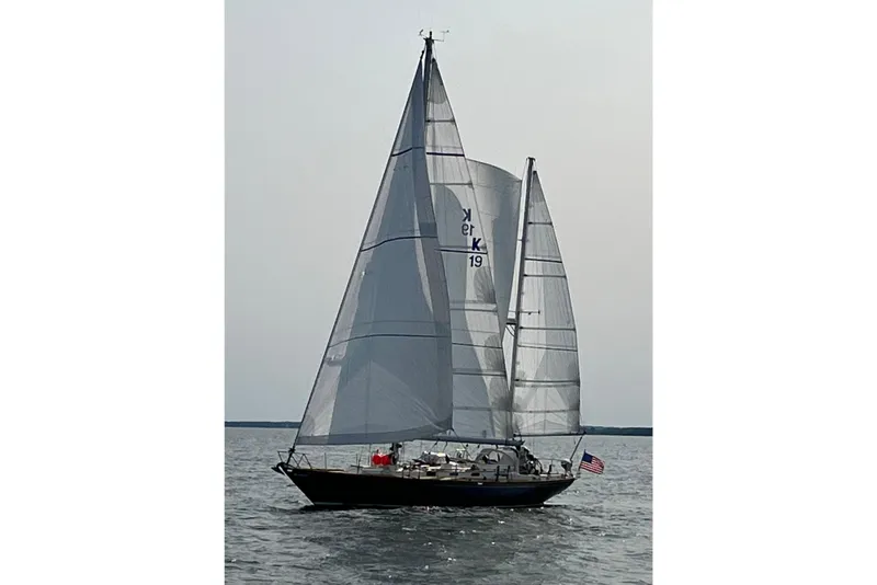 Slide: The Image of Sailing yacht F&C 44 from 1980 on open water with American flag. - 2