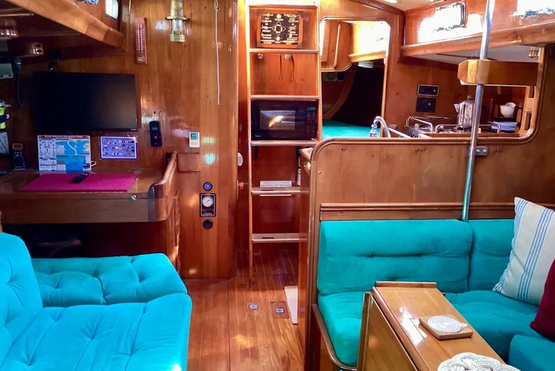 Slide: The Image of Interior of a 1980 F&C 44 yacht with wooden finish and teal seating. - 24